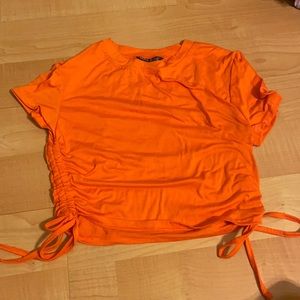 Small, solid drawstring side crop tee